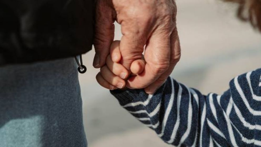 grandfather holding his grandson from command